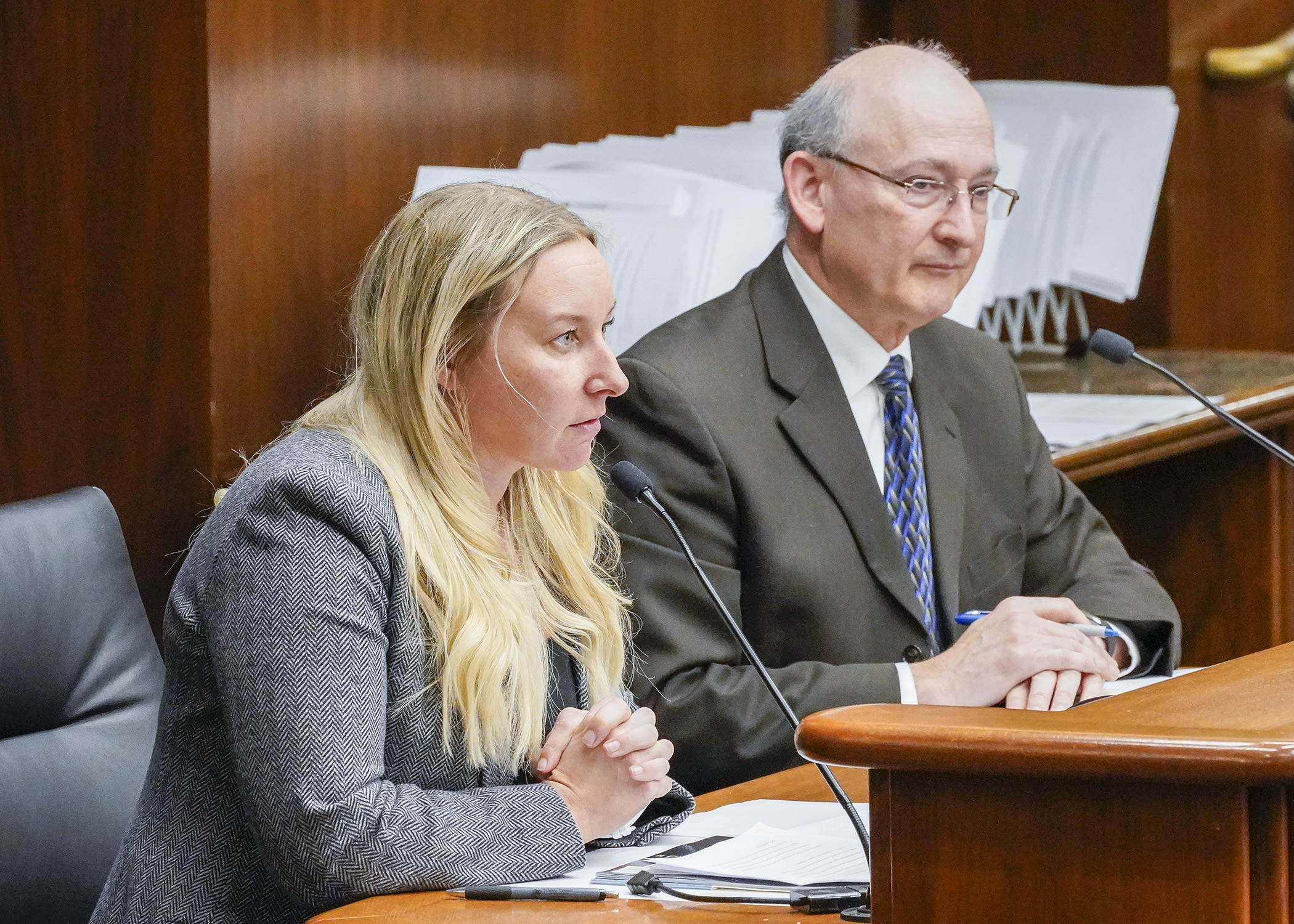 Rochelle Westlund, director of public policy for the Minnesota Association of Community Health Centers, testifies Feb. 16 in support of HF693, sponsored by Rep. Peter Fischer, right. (Photo by Andrew VonBank)